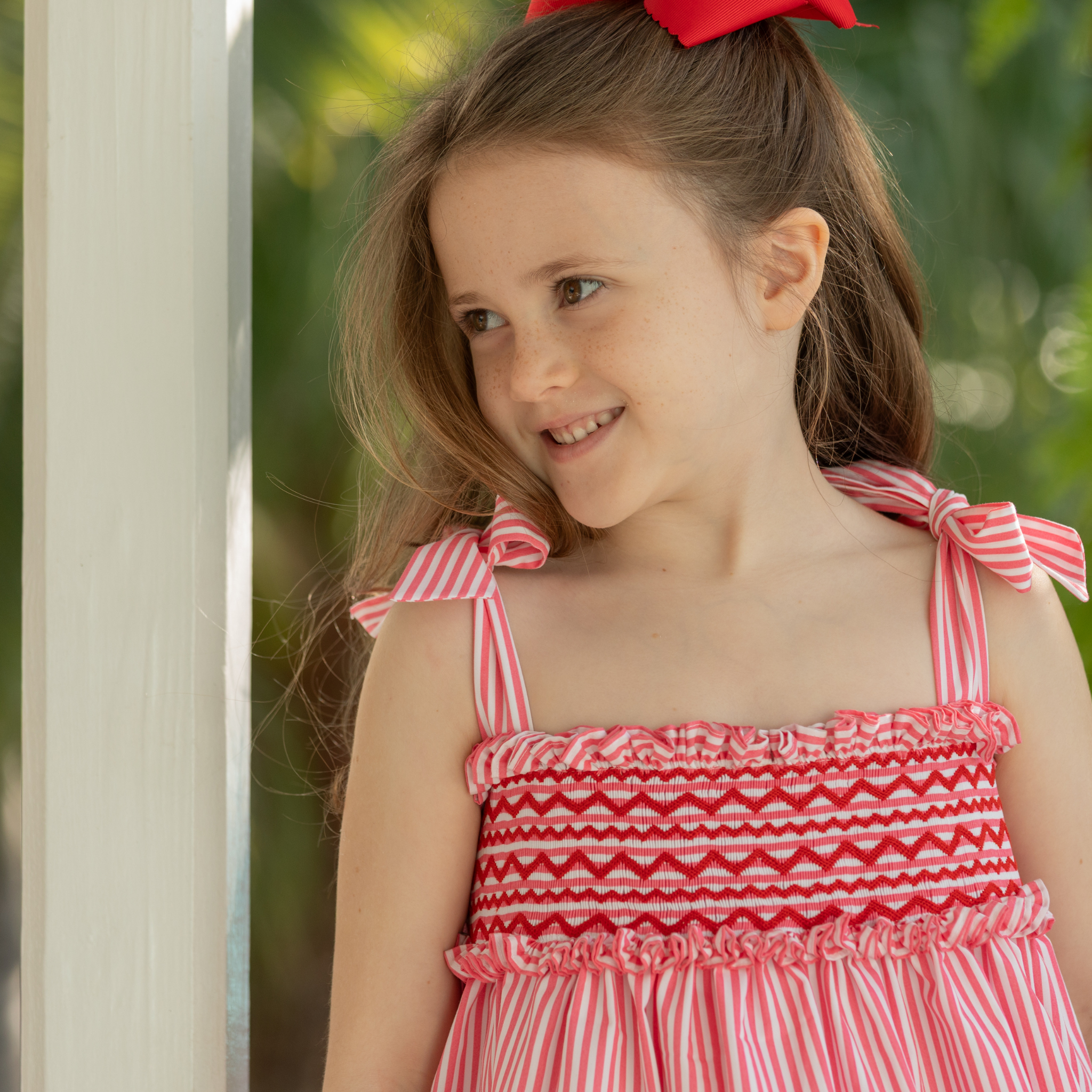 Henry Duvall Daisy Dress in red & white stripe print with hand-smocked bodice and shoulder bow ties, classic heirloom summer dress for girls