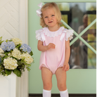 Toddler girl wearing the Henry Duvall Rosie Bubble, a classic pink bubble designed for spring days and special moments.