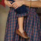 Women’s Audrey Skirt in navy, red, and green Tinsel Tartan with subtle metallic thread, featuring a full gathered midi-length silhouette.