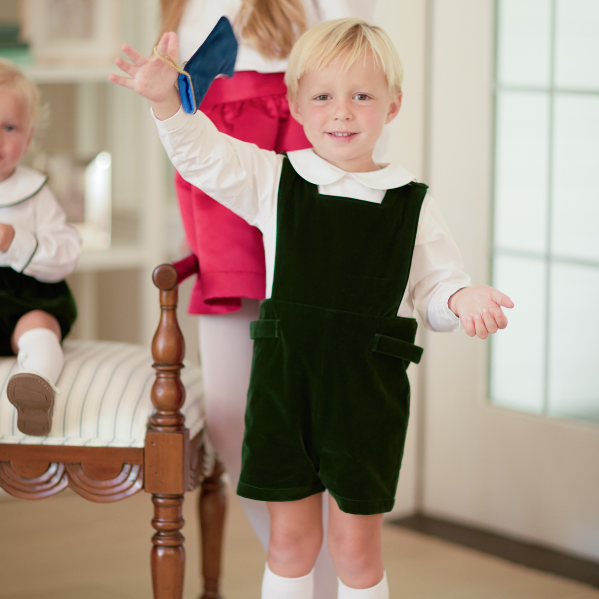 Boys’ James Henry Jon Jon in rich Grafton Green Velvet with signature gold buttons at the shoulders and side tabs.