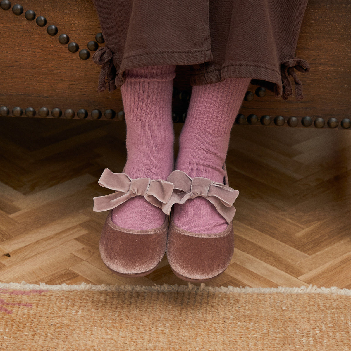 Andie Rose velvet Mary Jane in rose pink with velvet bow, worn by child with pink socks