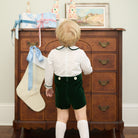 Boys’ Benjamin Button On with crisp white long-sleeve cotton poplin top, Grafton Green piping and pintuck details, paired with Grafton Green Velvet shorts and signature HD buttons.