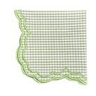 Green and white checkered napkin with scalloped edge on a white background