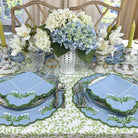 Elegant table setting with floral centerpieces and decorative plates.
