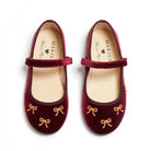 Meri Meri x Marjen Bowie burgundy velvet Mary Jane with gold bow embroidery, top-down view of pair