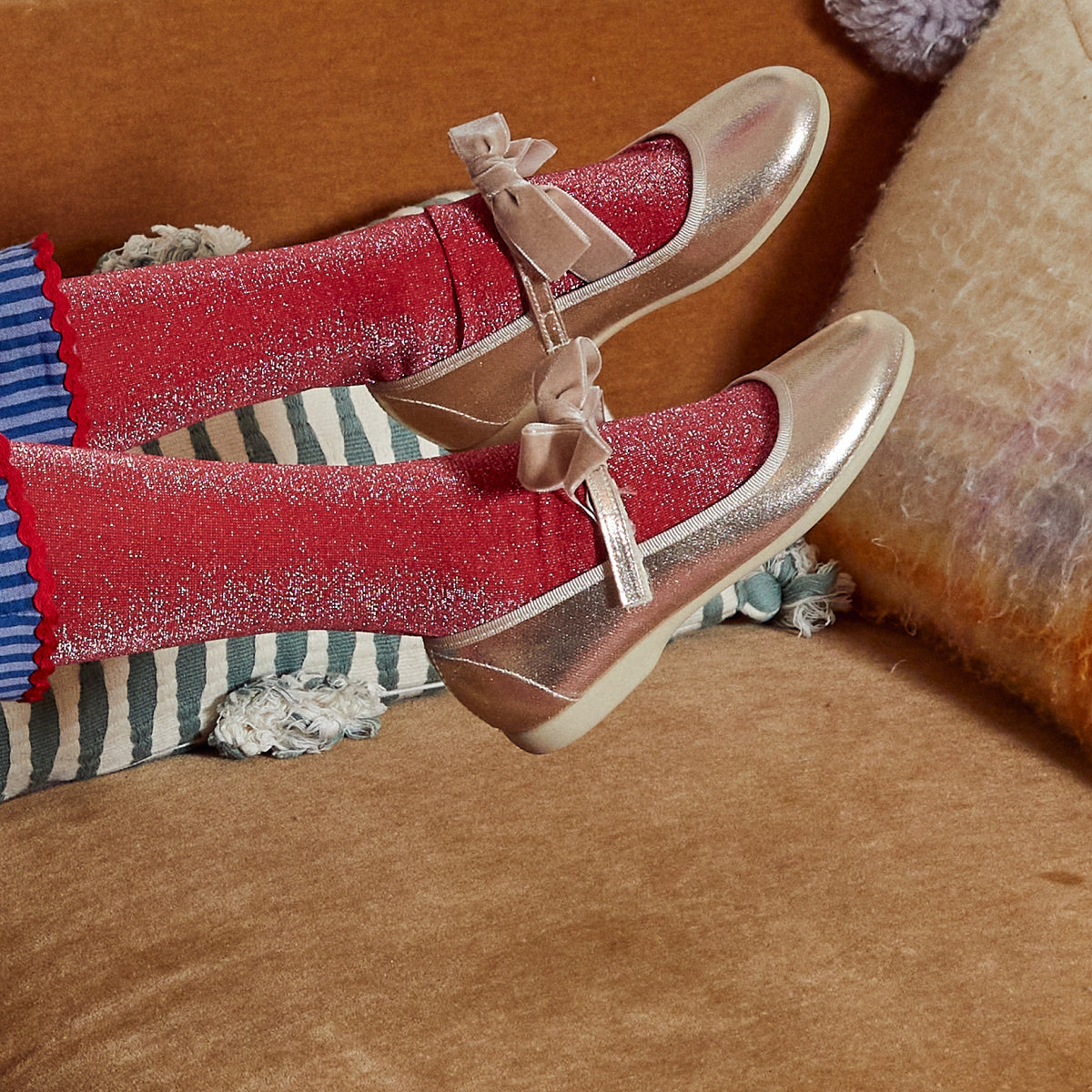 Meri Meri x Marjen Missy metallic gold Mary Jane with velvet bow, worn by child with red glitter socks