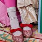 Meri Meri x Marjen Sabrina pink glitter Mary Jane with red velvet bow, close-up worn with silver socks