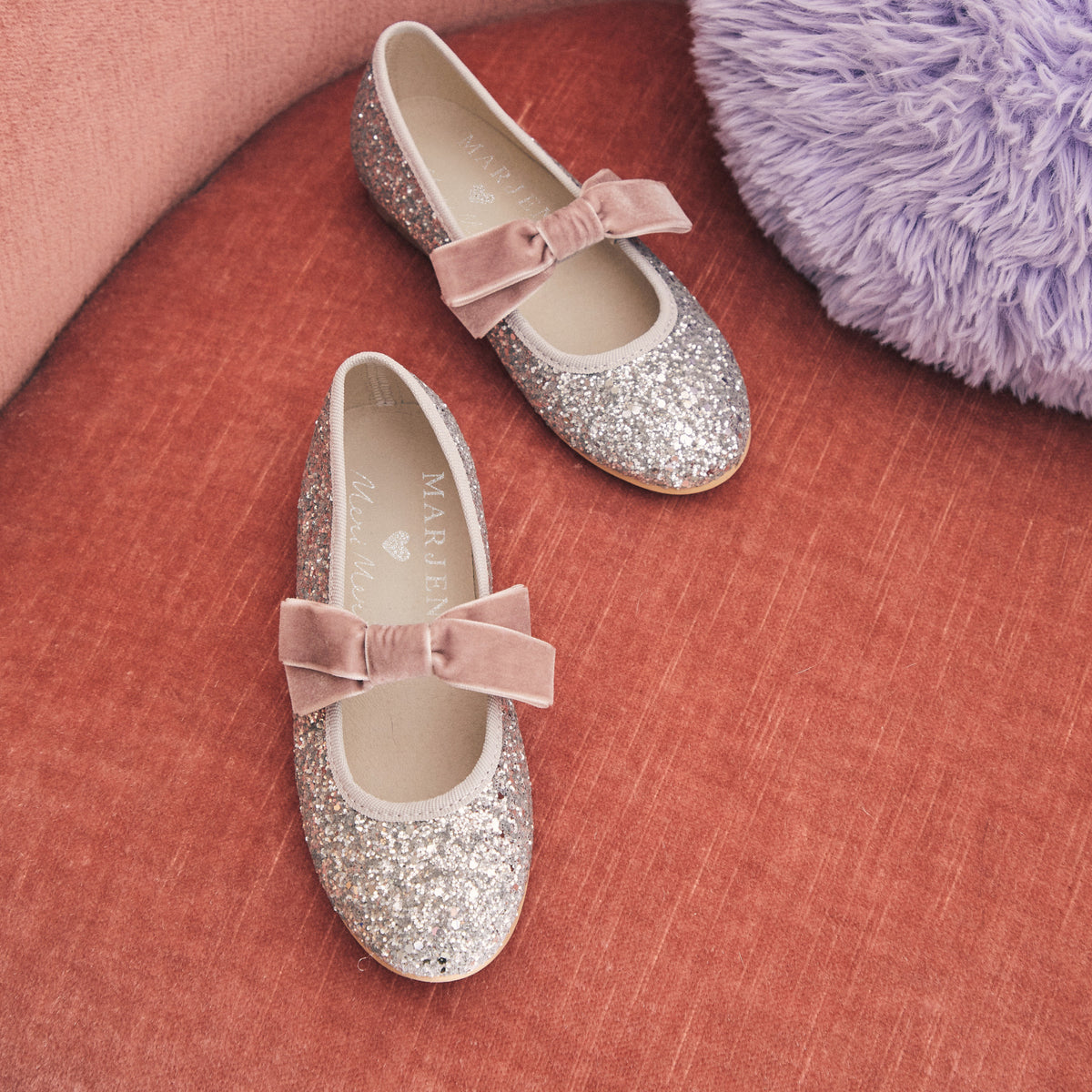 Meri Meri x Marjen Sabrina silver glitter Mary Jane with rose velvet bow, pair on a terracotta surface