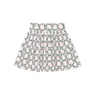 Girls’ Sutton Skirt in Regent Wreaths, featuring a festive green wreath and red star print on white with a full gathered silhouette.