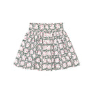 Girls’ Sutton Skirt in Regent Wreaths, featuring a festive green wreath and red star print on white with a full gathered silhouette.
